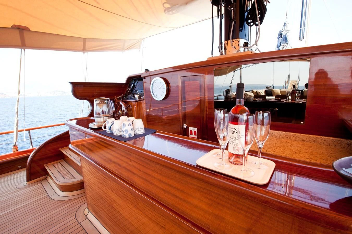 a table with wine glasses and bottles on it aboard PERFORMANCE FEE Yacht for Sale