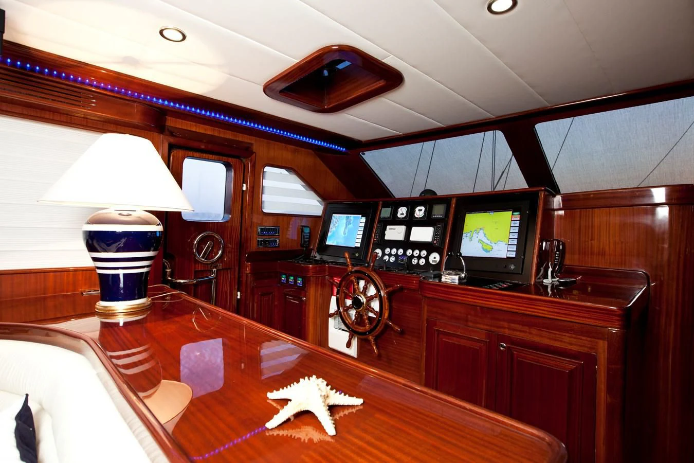 a room with a table and tv aboard PERFORMANCE FEE Yacht for Sale