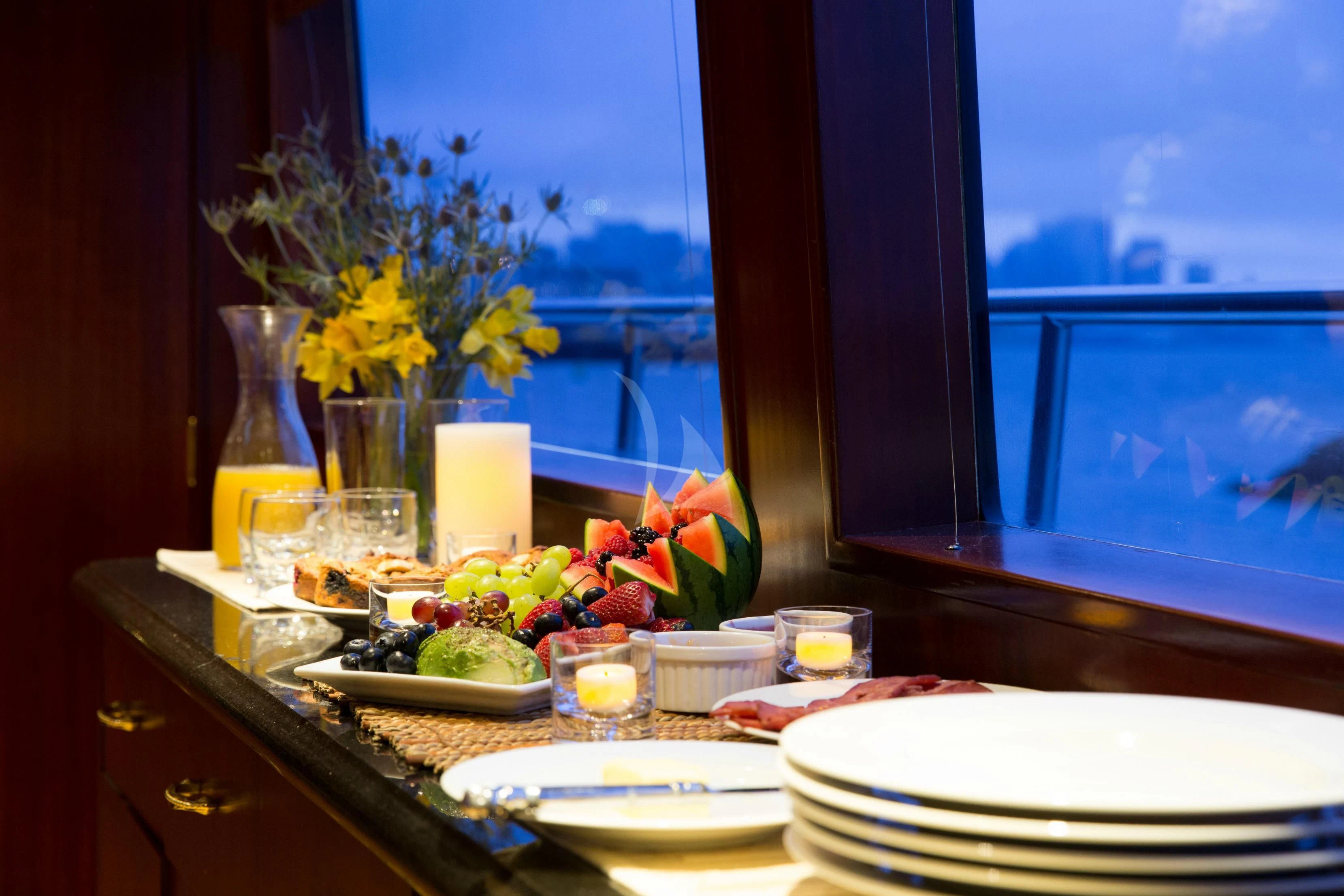 a table with plates and glasses aboard BLACKWOOD Yacht for Sale