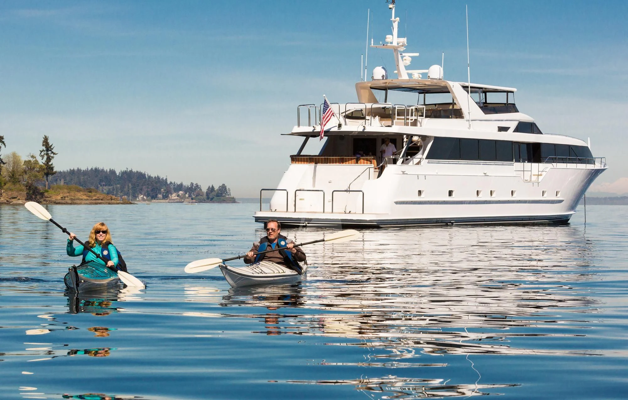 a group of people in a boat with a large boat in the background aboard BLACKWOOD Yacht for Sale