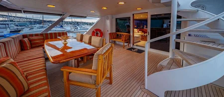 a room with a couch and a table and chairs aboard BLACKWOOD Yacht for Sale