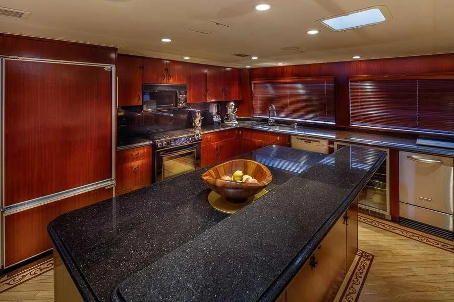a kitchen with black counter tops aboard BLACKWOOD Yacht for Sale