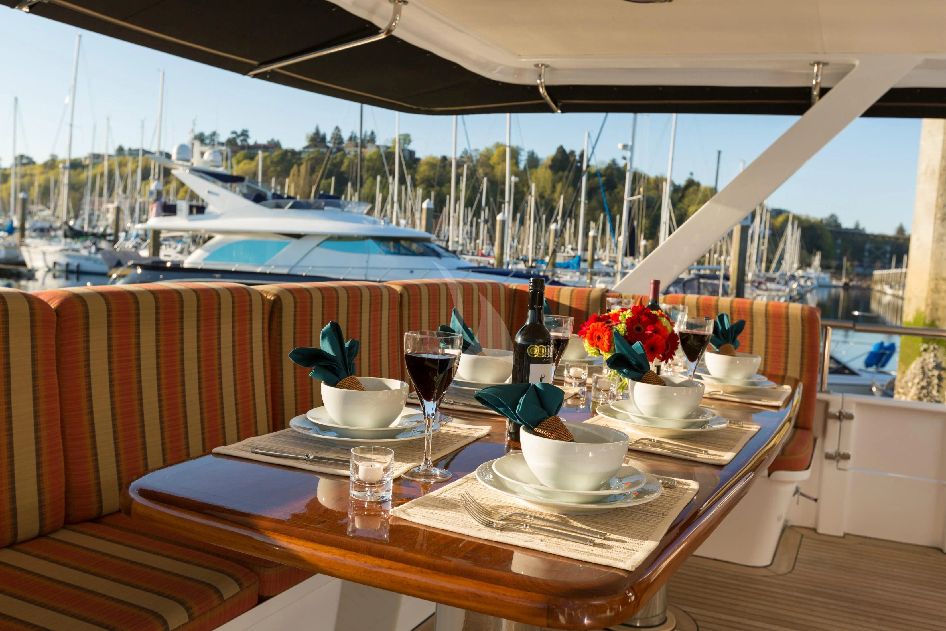 a table with plates and cups on it aboard BLACKWOOD Yacht for Sale