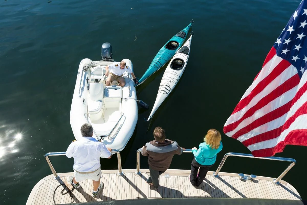 a group of people on a boat with a flag aboard BLACKWOOD Yacht for Sale