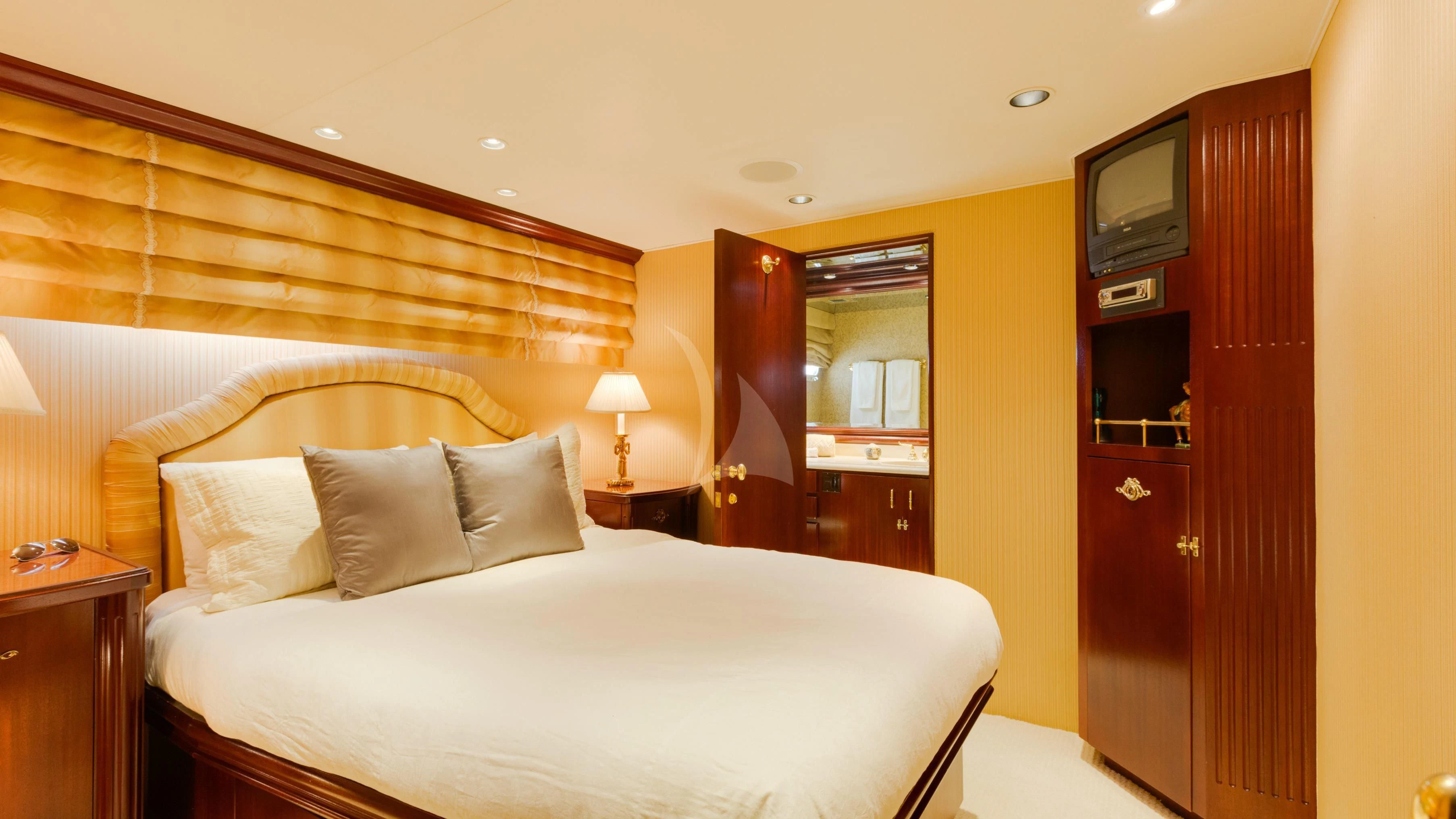 a hotel room with a bed and a television aboard BLACKWOOD Yacht for Sale