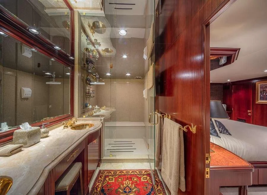 a room with a bed and a mirror aboard BLACKWOOD Yacht for Sale