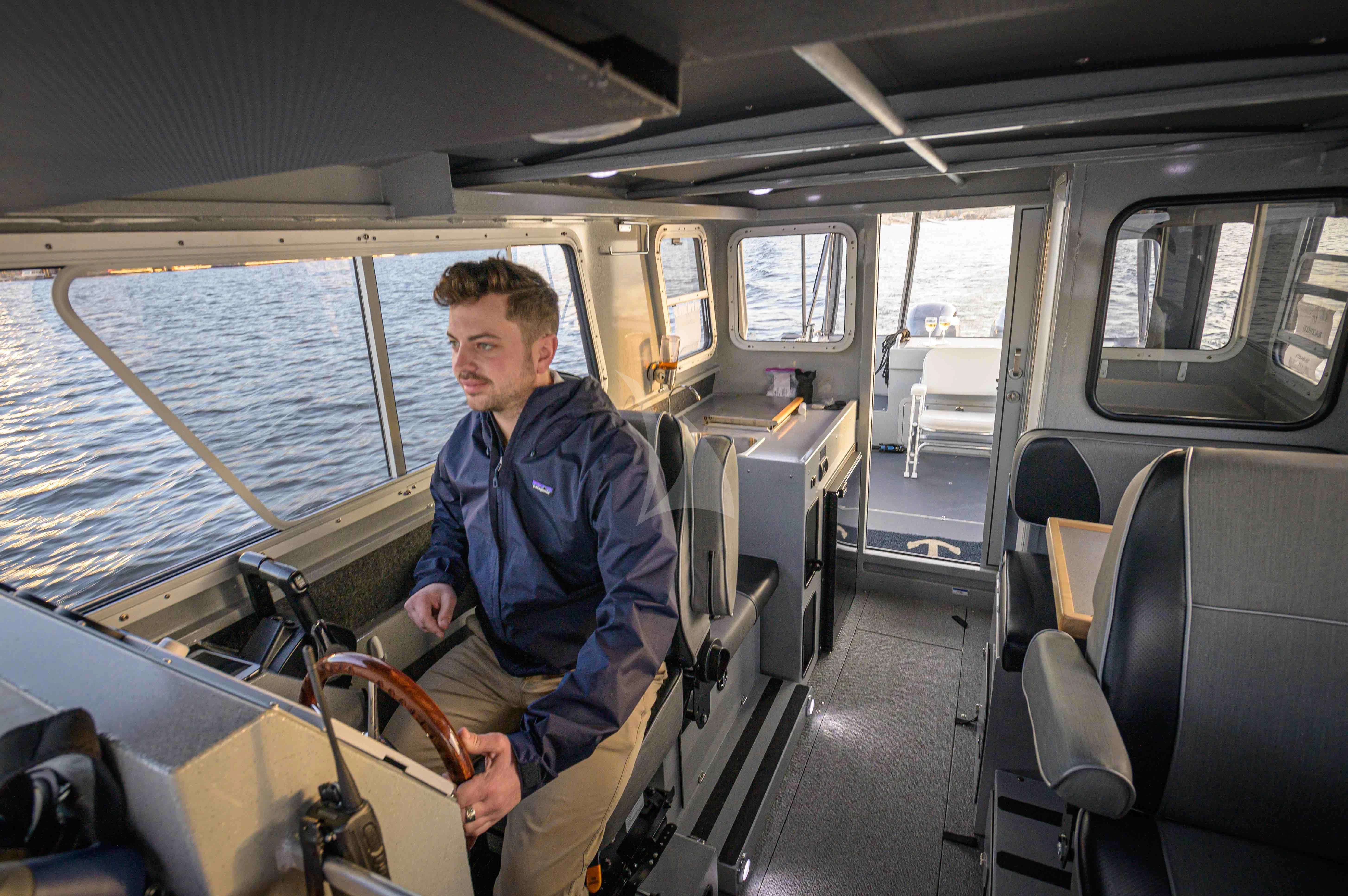 a man sitting on a boat aboard BLACKWOOD Yacht for Sale