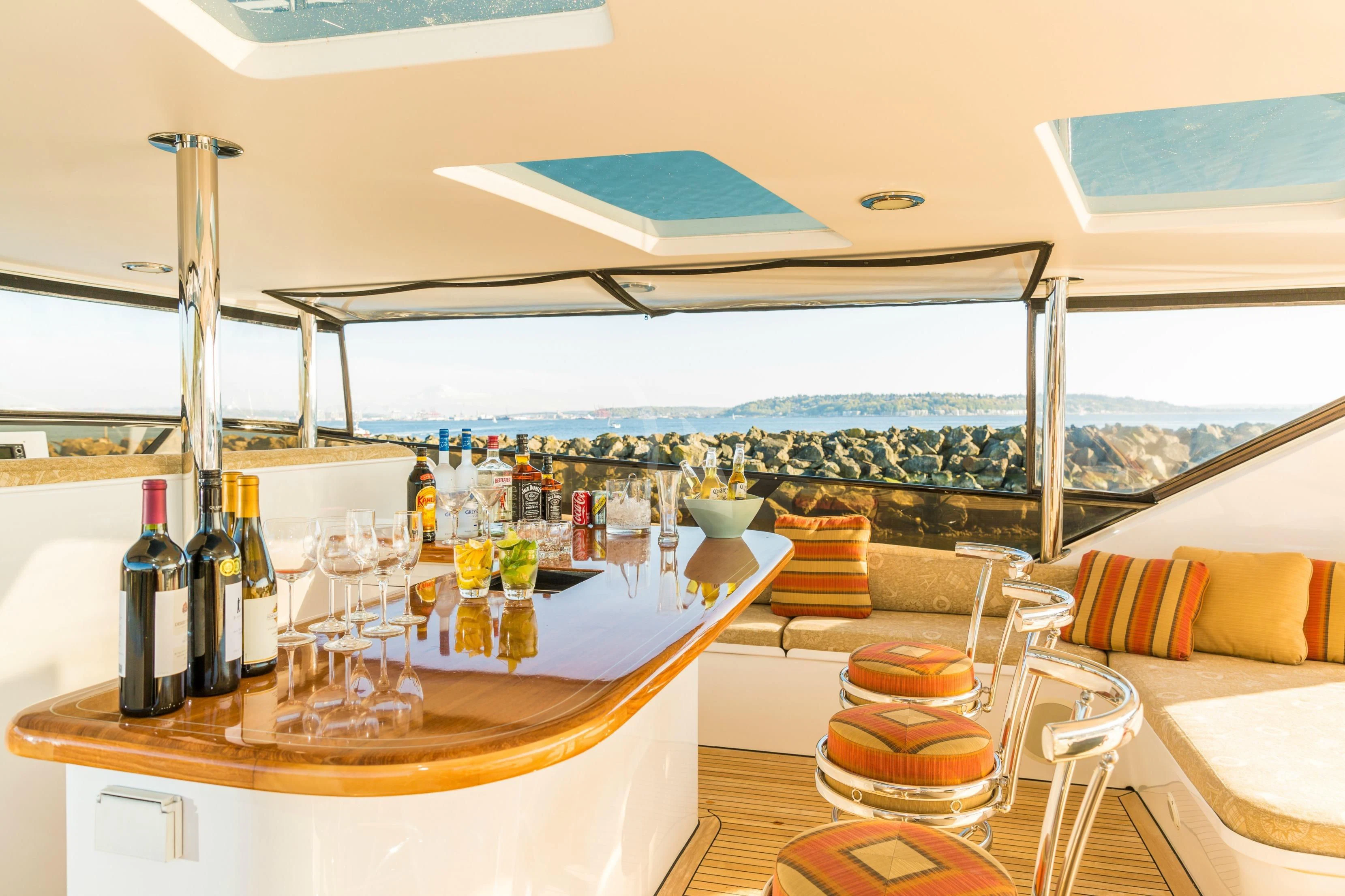 a table with wine bottles and glasses aboard BLACKWOOD Yacht for Sale