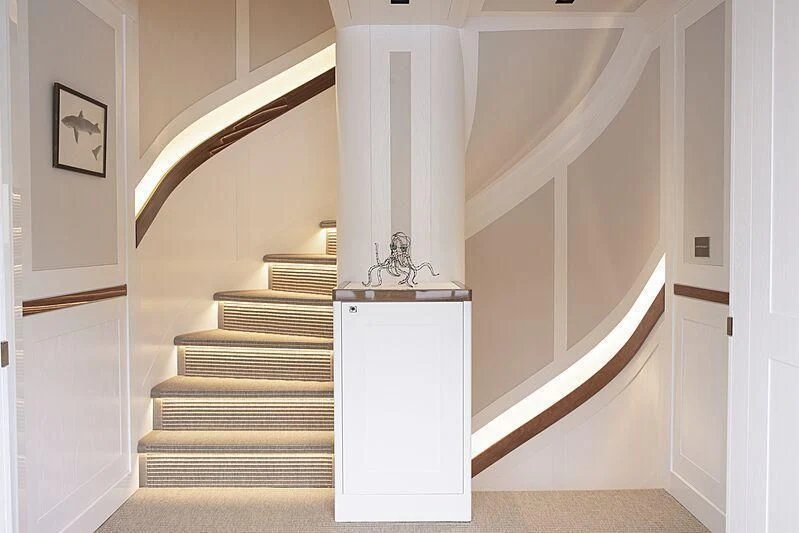 a white staircase with a white column aboard BLUE II Yacht for Charter