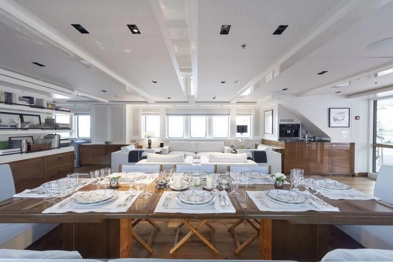 a large kitchen with white tables aboard BLUE II Yacht for Charter