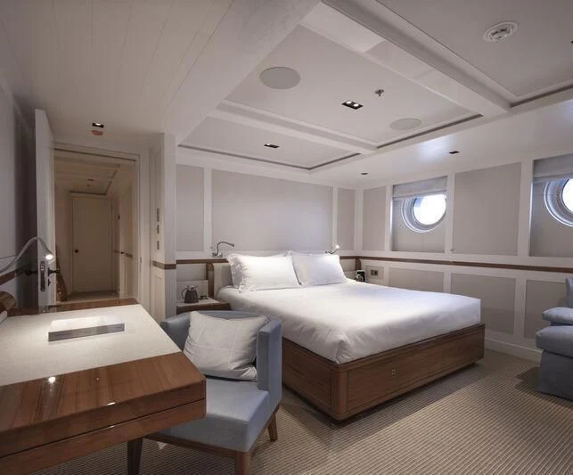 a room with a bed and a desk aboard BLUE II Yacht for Charter