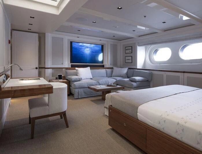 a room with a bed and a couch aboard BLUE II Yacht for Charter