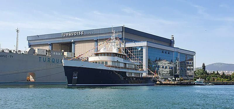 a large boat docked at a pier aboard BLUE II Yacht for Charter