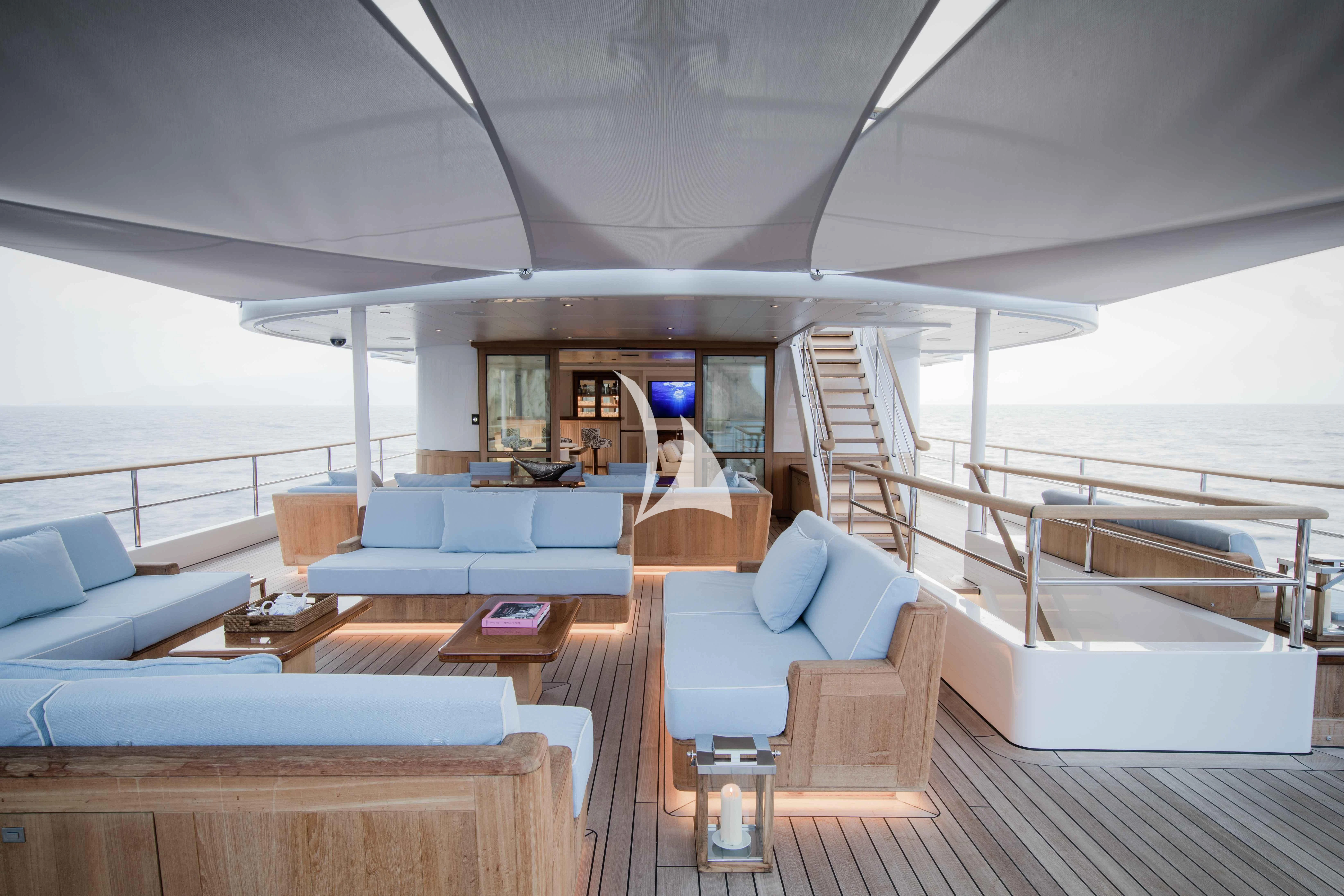 a room with a large deck and a view of the ocean aboard BLUE II Yacht for Charter