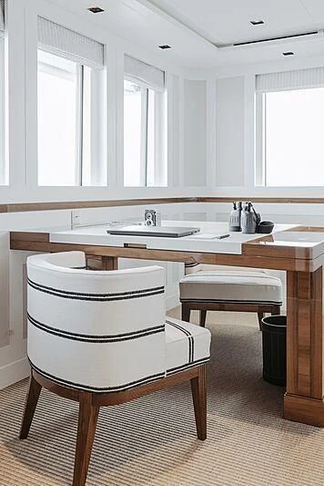 a kitchen with a white chair aboard BLUE II Yacht for Charter