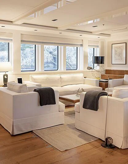 a living room with white couches aboard BLUE II Yacht for Charter