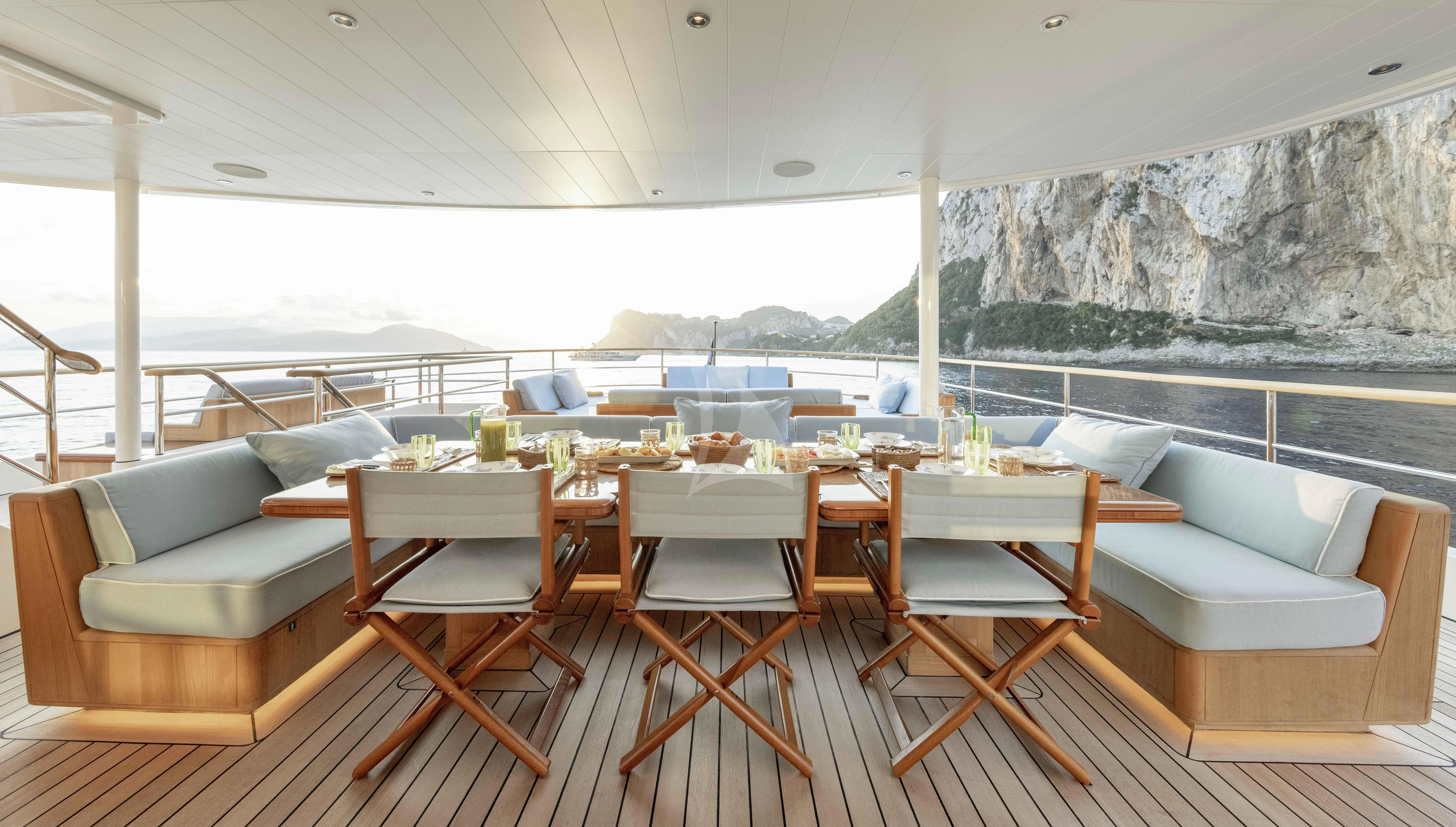 a room with a table and chairs aboard BLUE II Yacht for Charter