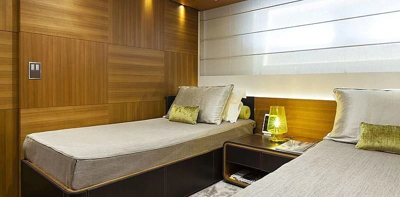 a room with a bed and a lamp aboard PACHAMAMA Yacht for Sale