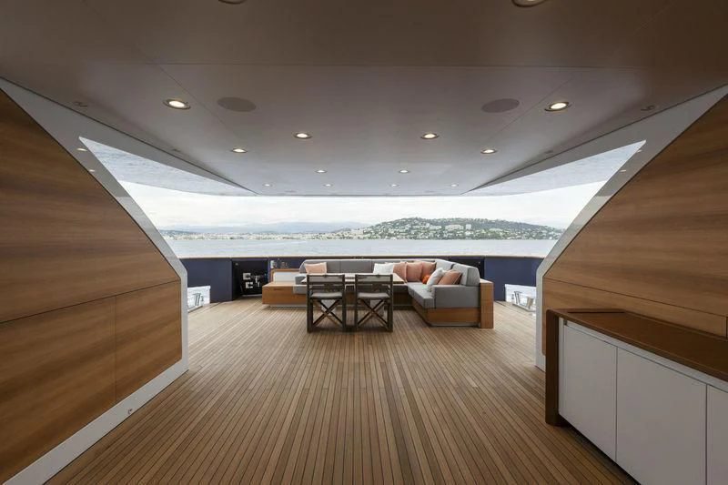 a room with a couch and a table and a large body of water aboard PACHAMAMA Yacht for Sale