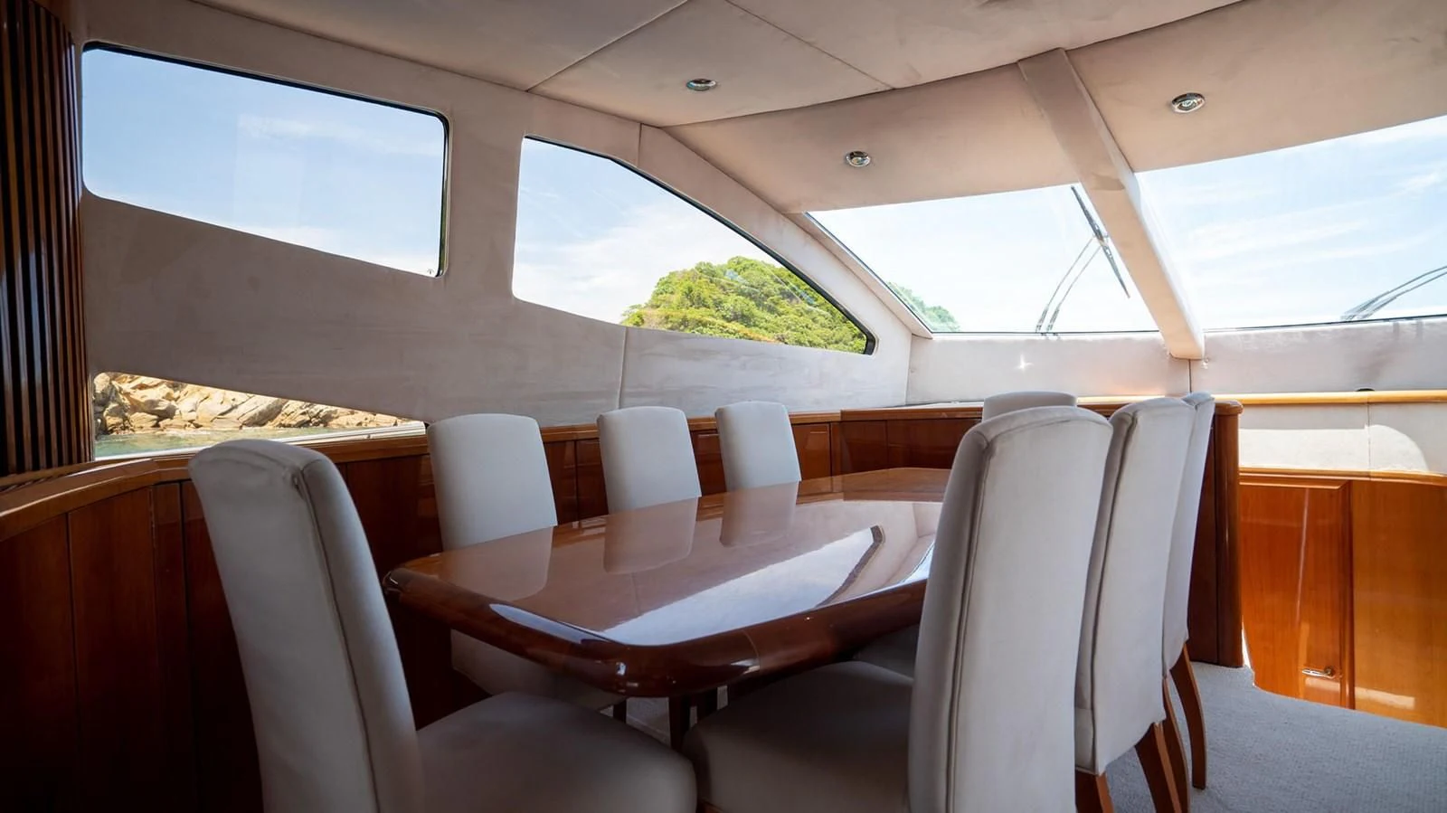 inside of a vehicle with chairs and tables and a large window aboard HAN SOLO Yacht for Sale