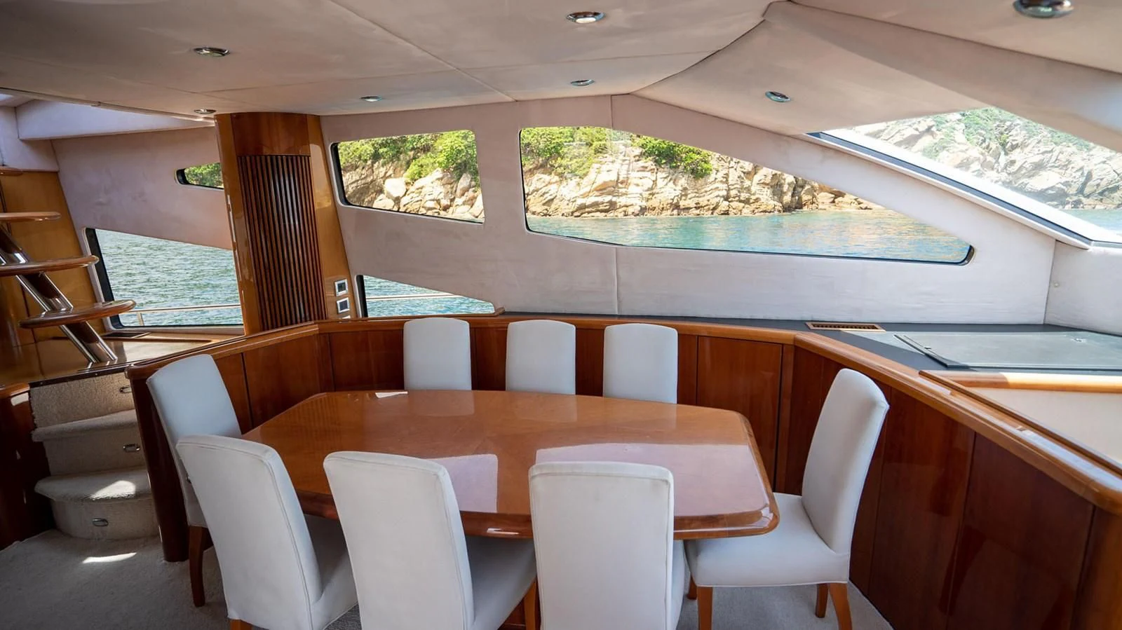 a room with a large table and chairs and a large window with a view of the water and aboard HAN SOLO Yacht for Sale