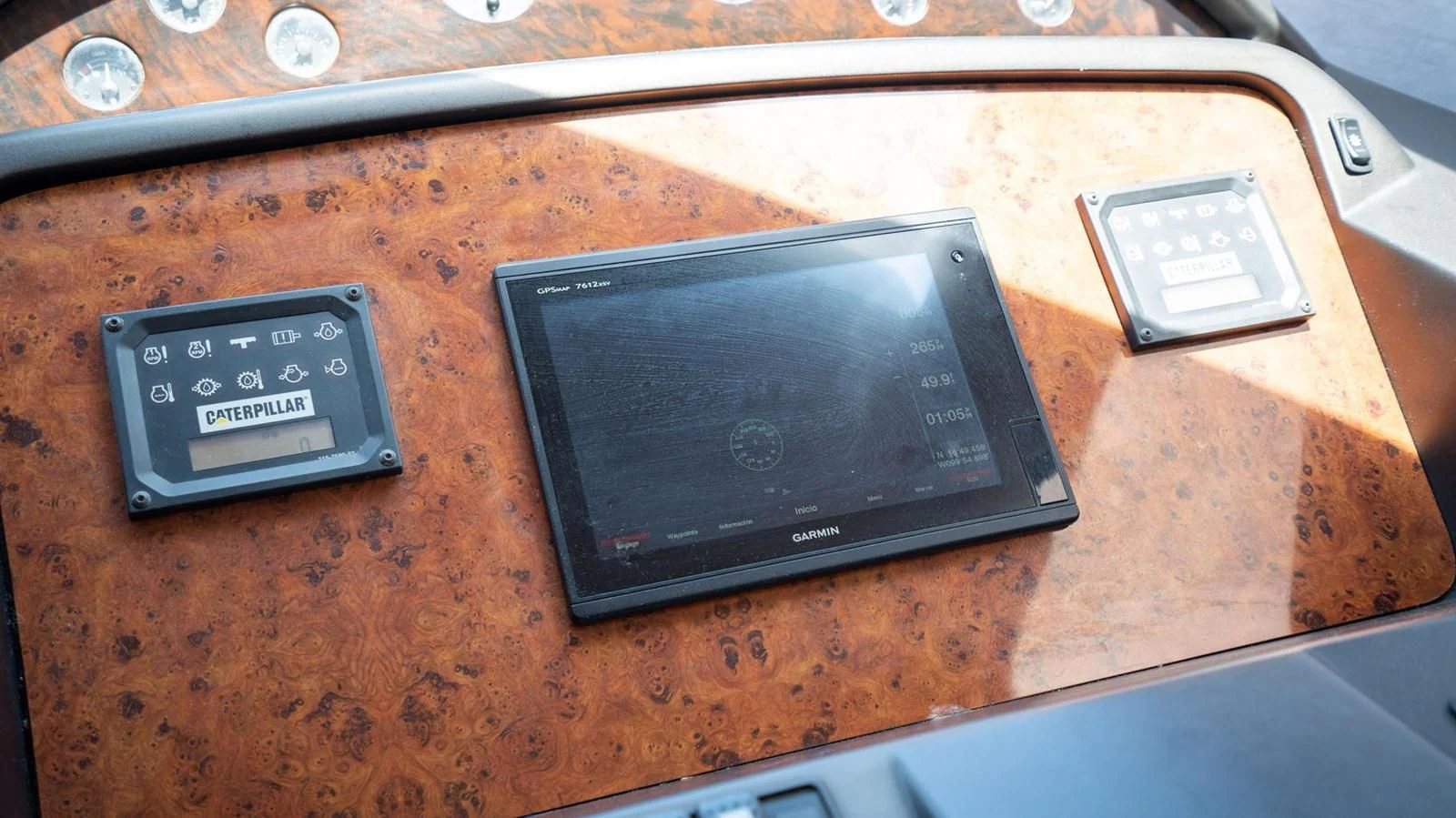 a black rectangular device on a wooden surface aboard HAN SOLO Yacht for Sale