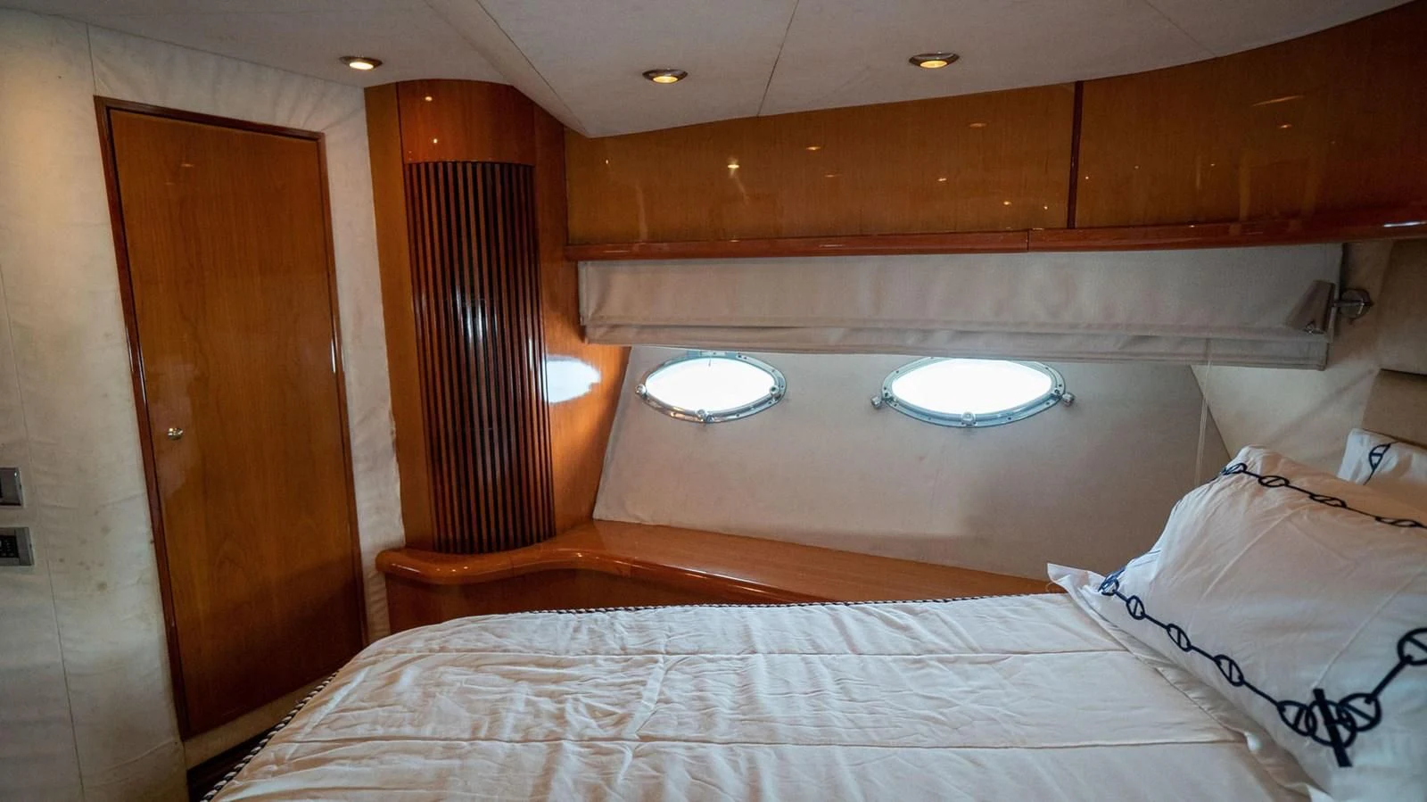 a bed with a white bed spread aboard HAN SOLO Yacht for Sale