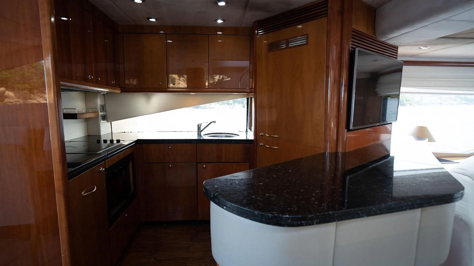 a kitchen with wooden cabinets aboard HAN SOLO Yacht for Sale