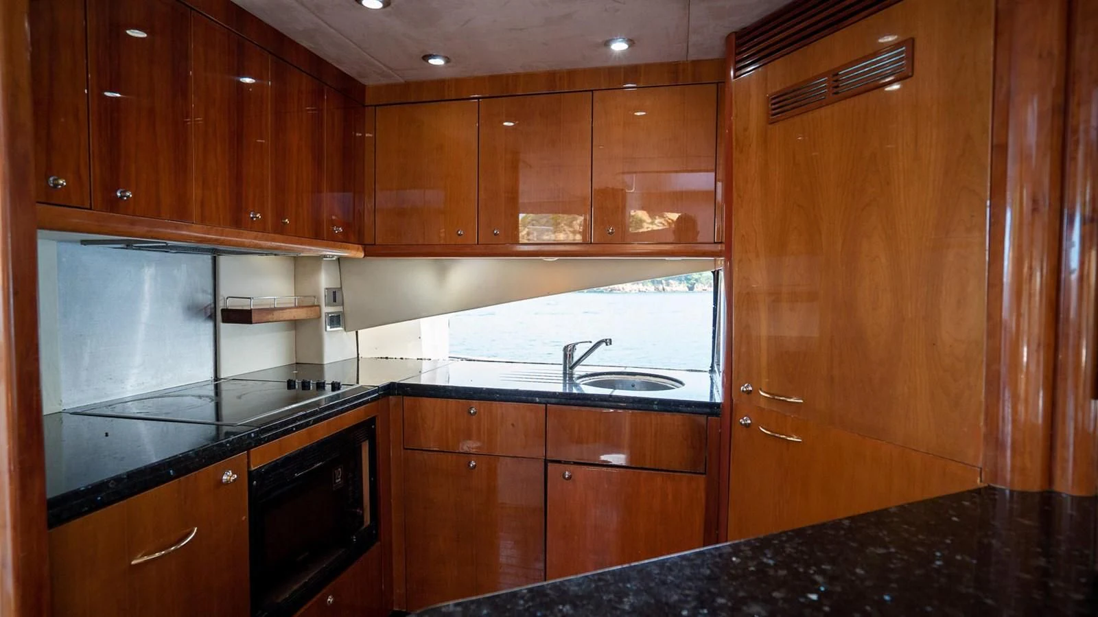 a kitchen with wooden cabinets aboard HAN SOLO Yacht for Sale