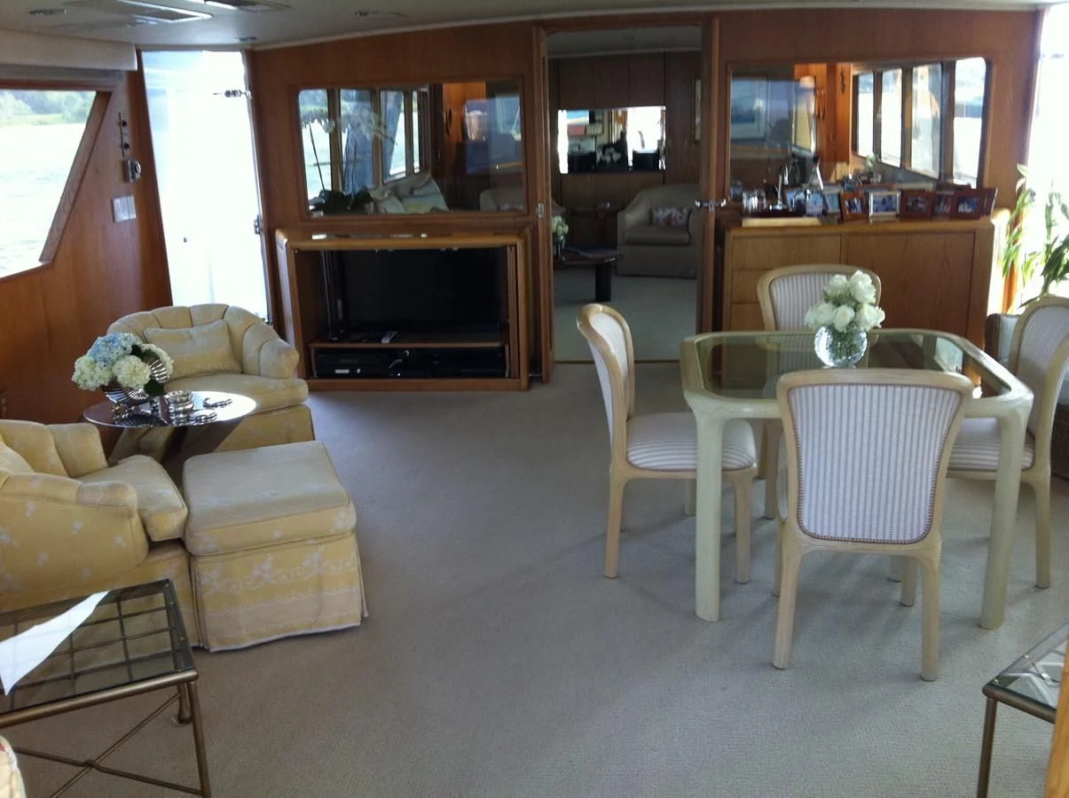 a living room with a table and chairs aboard ZANTINO III Yacht for Sale