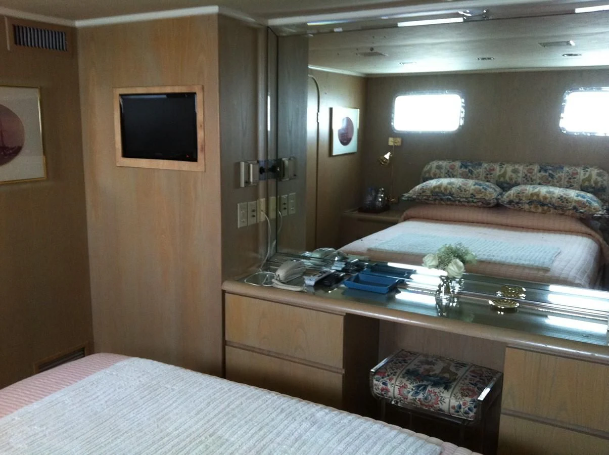 a room with a bed and a tv on the wall aboard ZANTINO III Yacht for Sale