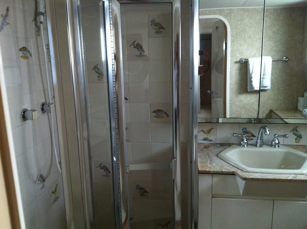 a bathroom with a shower and sink aboard ZANTINO III Yacht for Sale
