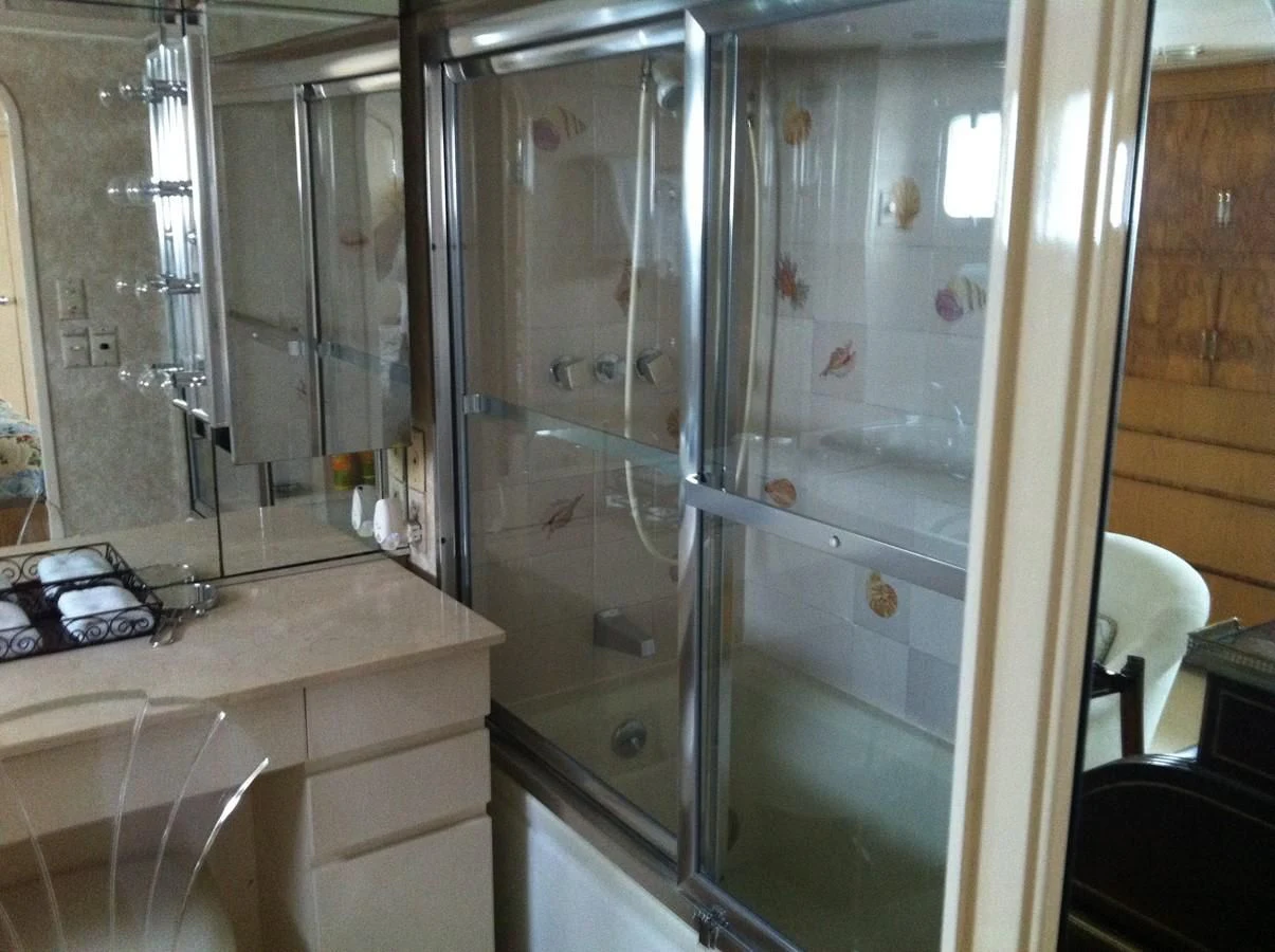 a bathroom with a glass shower aboard ZANTINO III Yacht for Sale