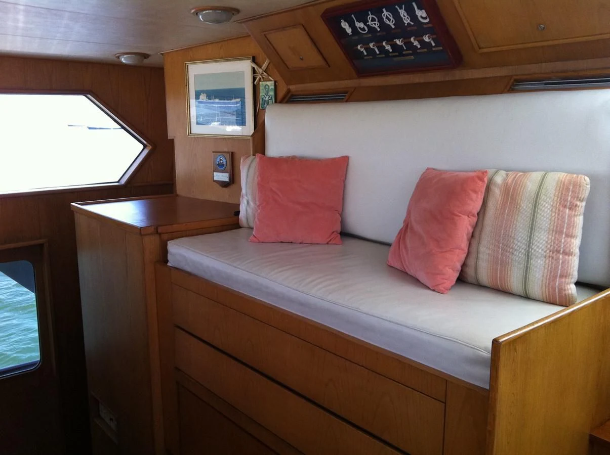 a couch with pillows on it aboard ZANTINO III Yacht for Sale
