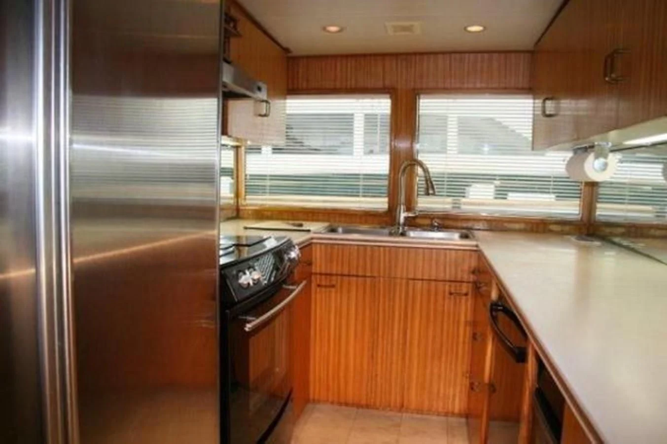 a kitchen with wooden cabinets aboard ZANTINO III Yacht for Sale