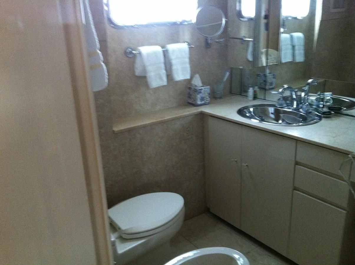 a bathroom with a sink toilet and a mirror aboard ZANTINO III Yacht for Sale
