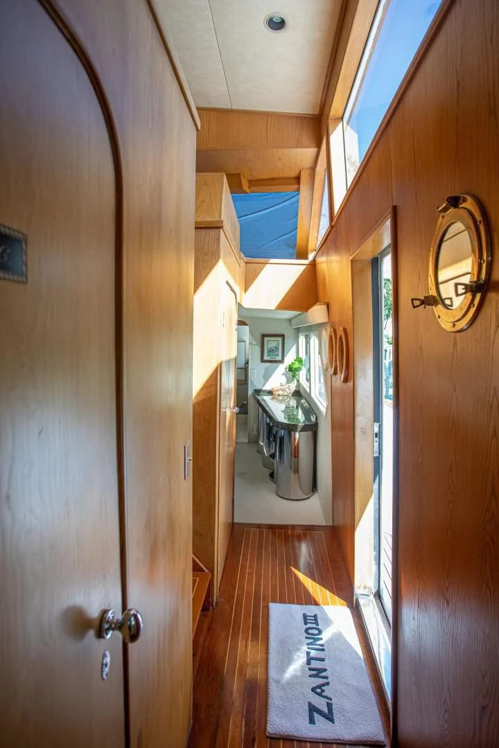 a hallway with a door and a mirror aboard ZANTINO III Yacht for Sale