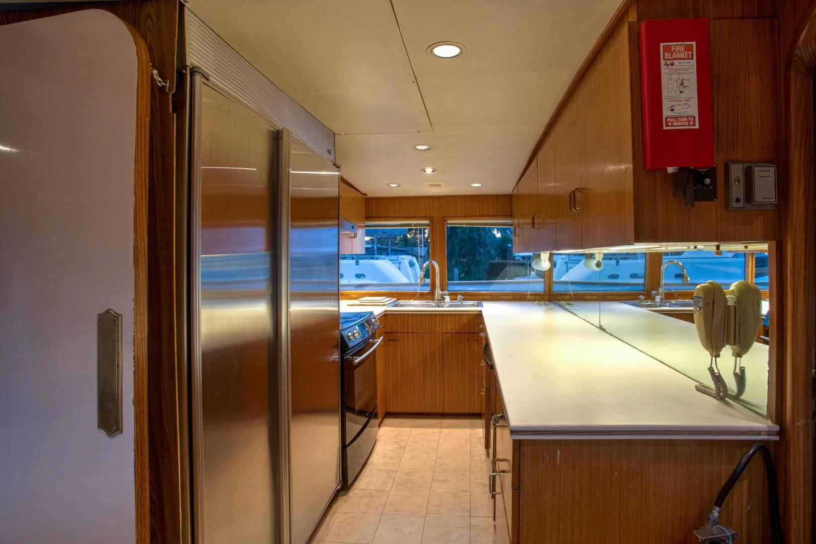 a room with a glass door and a counter with a sink and a mirror aboard ZANTINO III Yacht for Sale