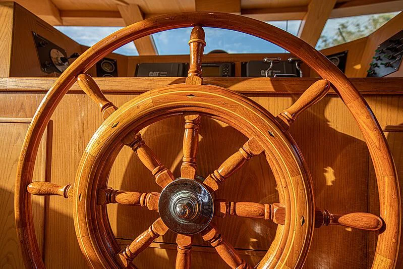 a wooden steering wheel aboard ZANTINO III Yacht for Sale