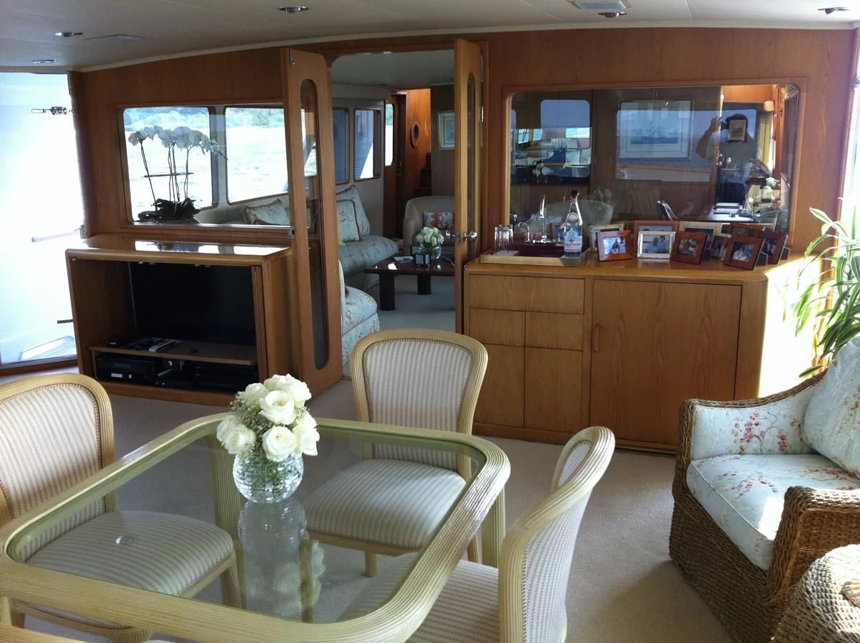 a living room with a piano and a table aboard ZANTINO III Yacht for Sale