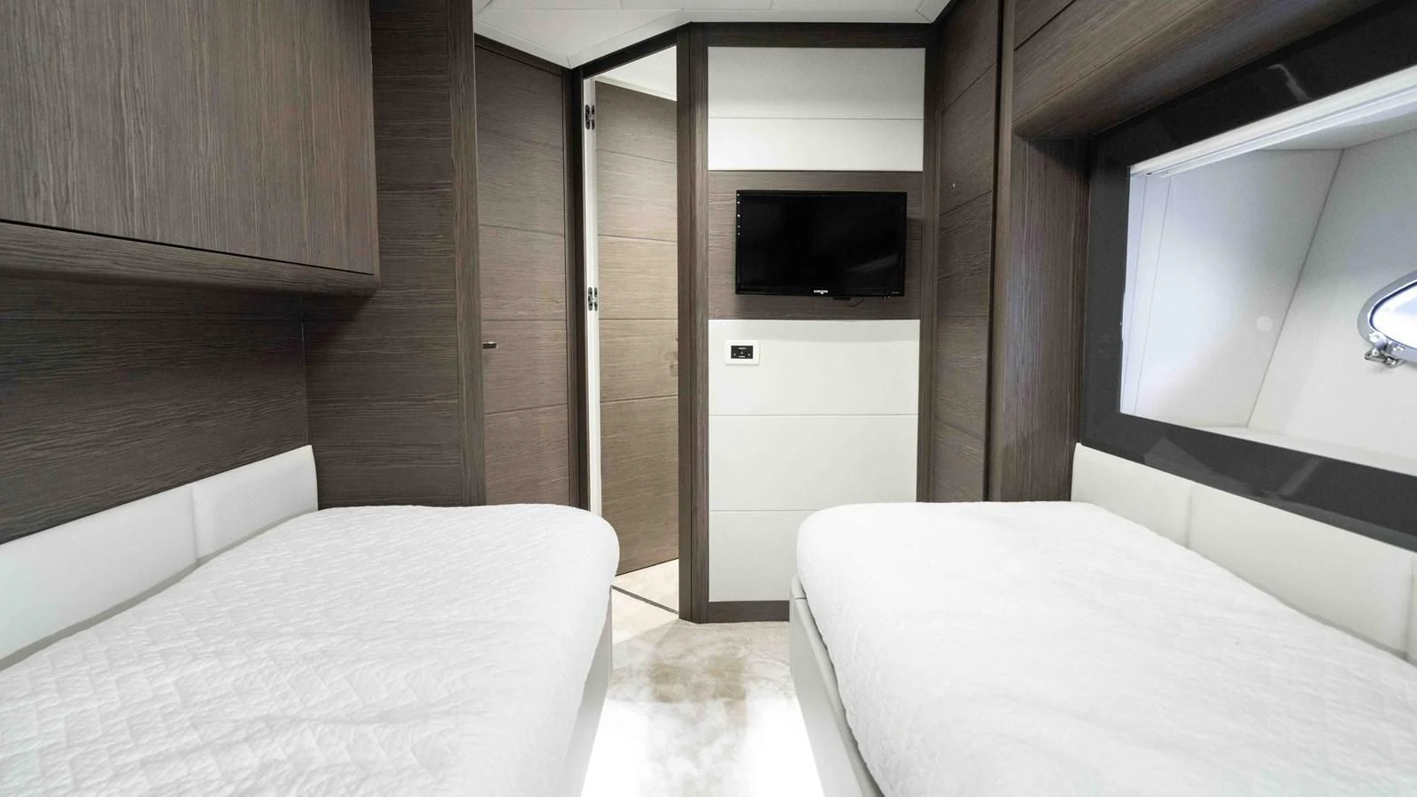 a room with a bed and a television aboard UPTOWN GIRL Yacht for Sale