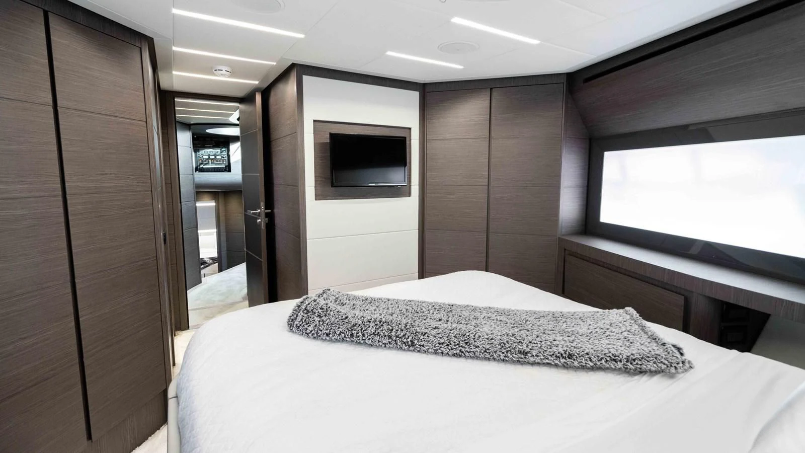 a room with a bed and a television aboard UPTOWN GIRL Yacht for Sale