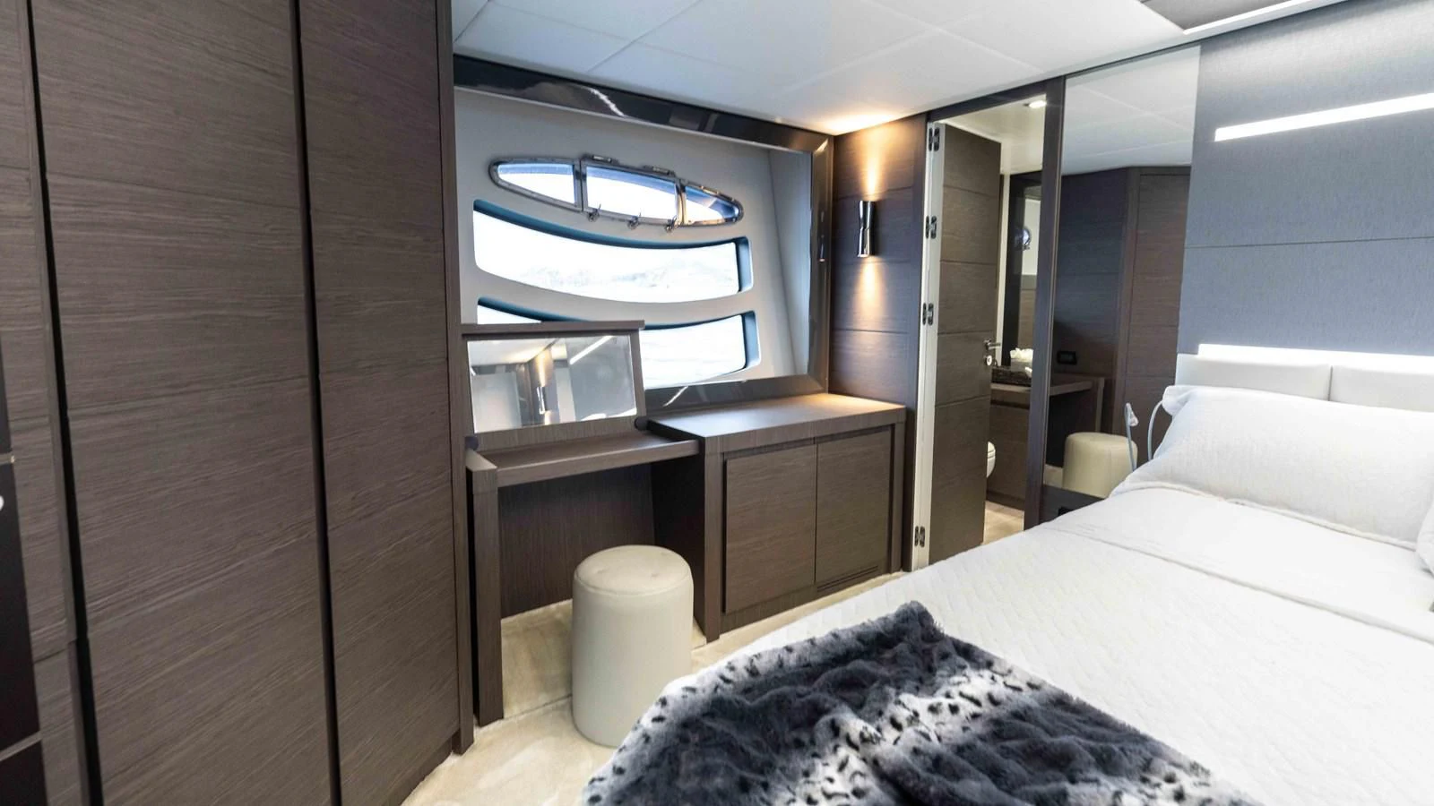 a room with a bed and a desk aboard UPTOWN GIRL Yacht for Sale