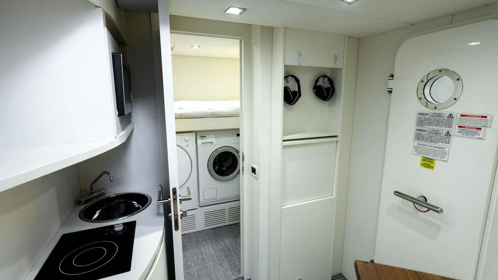 a kitchen with a washing machine and sink aboard UPTOWN GIRL Yacht for Sale