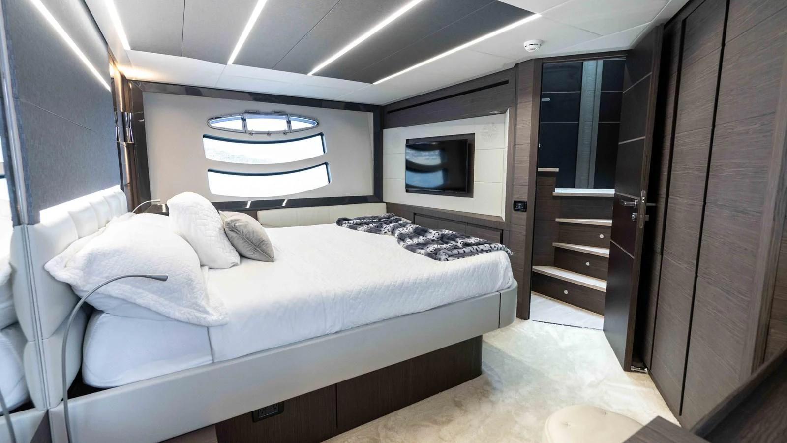 a room with a bed and a television aboard UPTOWN GIRL Yacht for Sale