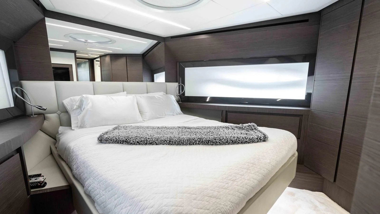 a bed with a white bed spread aboard UPTOWN GIRL Yacht for Sale