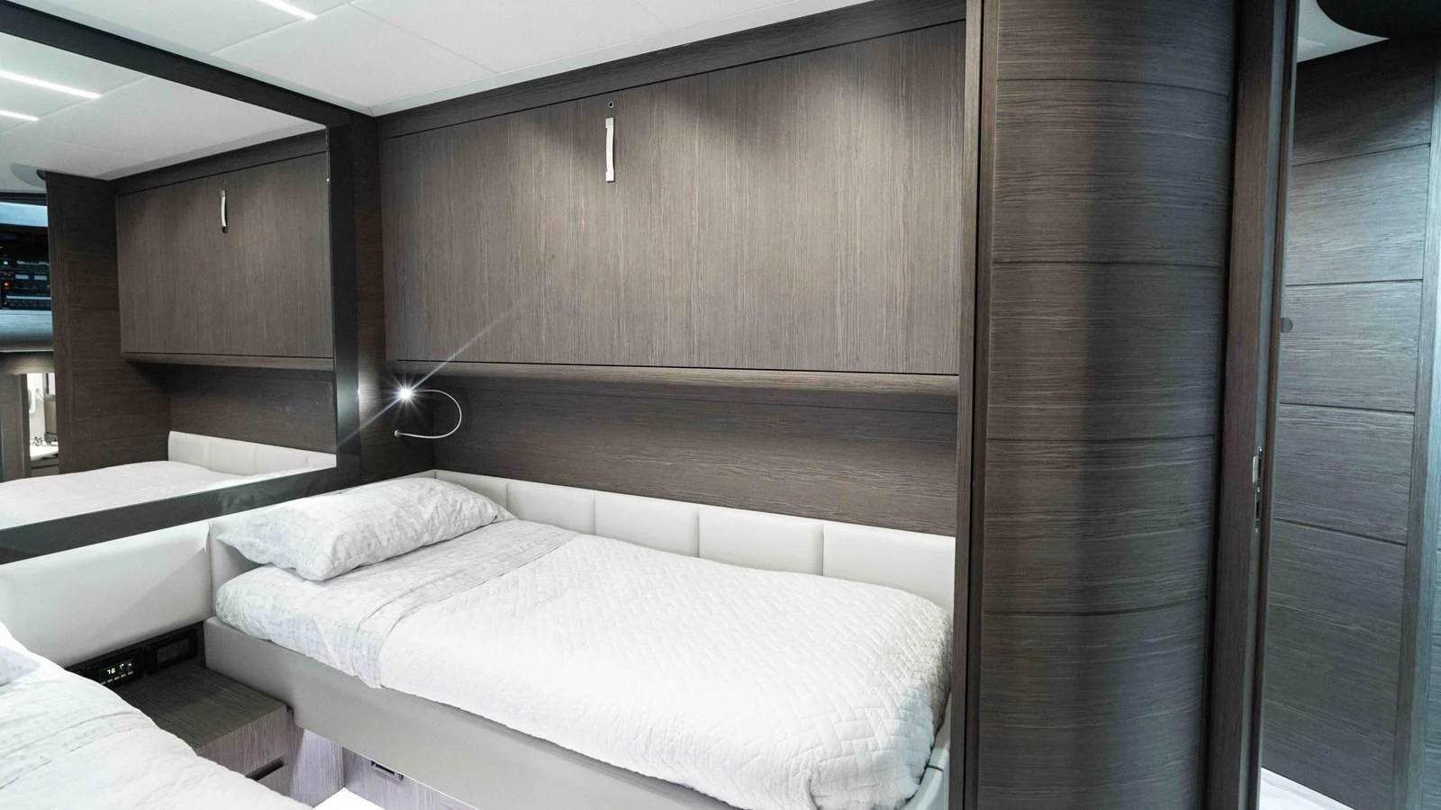 a room with a bed and a wood wall aboard UPTOWN GIRL Yacht for Sale