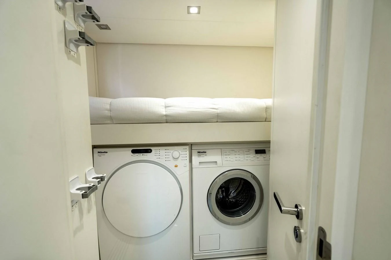 a white washing machine aboard UPTOWN GIRL Yacht for Sale