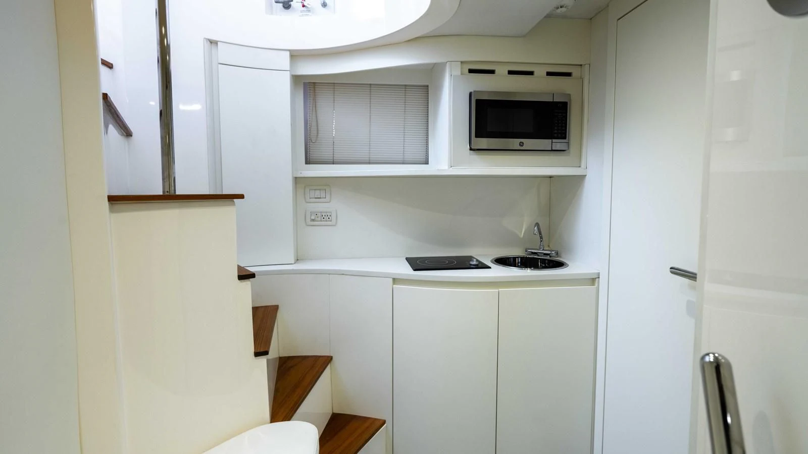 a microwave oven on a white microwave oven on a white cabinet aboard UPTOWN GIRL Yacht for Sale