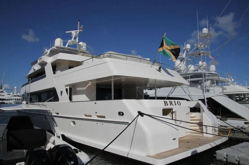 a white yacht with blue flags aboard SEA AXIS Yacht for Charter